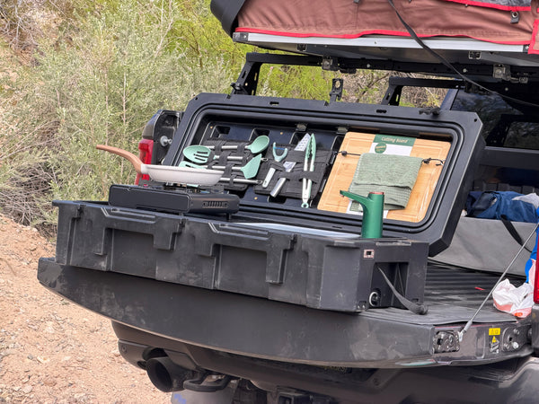 Compact portable camp kitchen being carried to a campsite