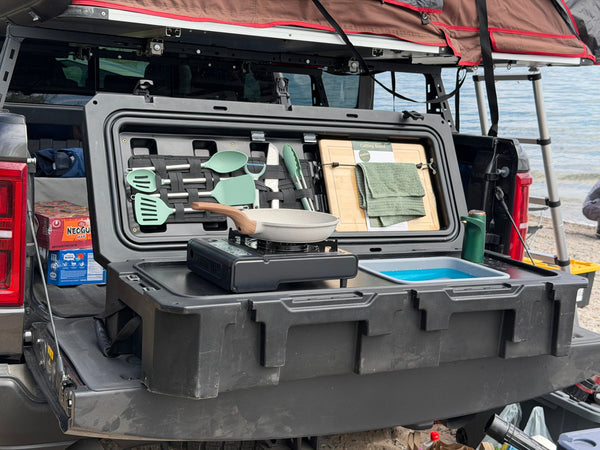 Camp kitchen with built-in sink and USB faucet running water outdoors