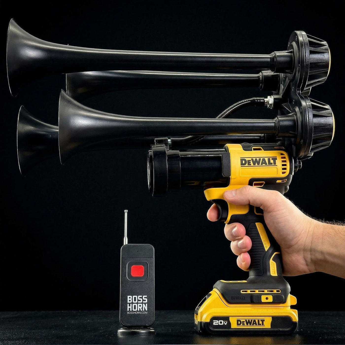 Black four-trumpet wildlife deterrent camp horn with wireless remote on a dark background
