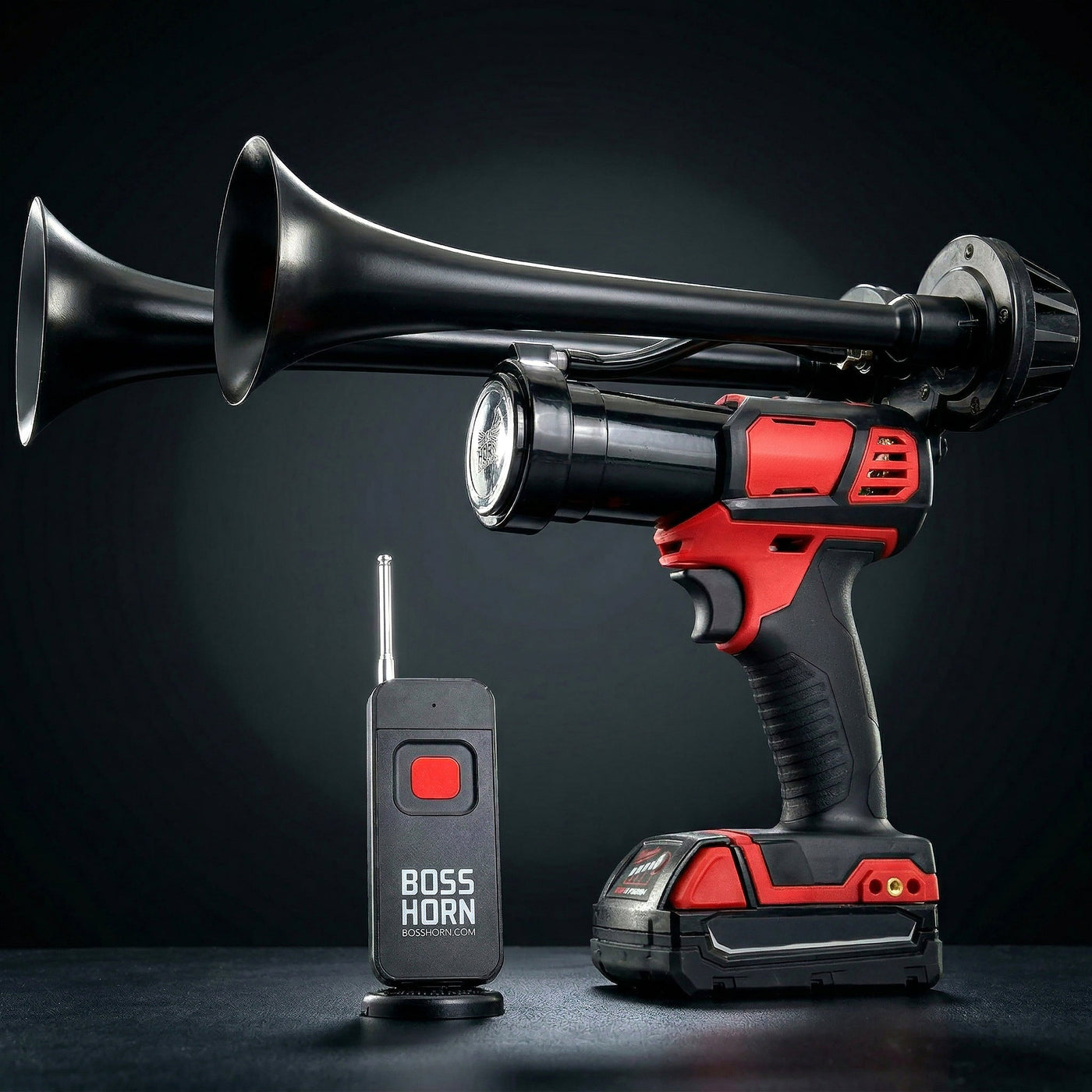 Black dual-trumpet wildlife deterrent camp horn with wireless remote on a dark background