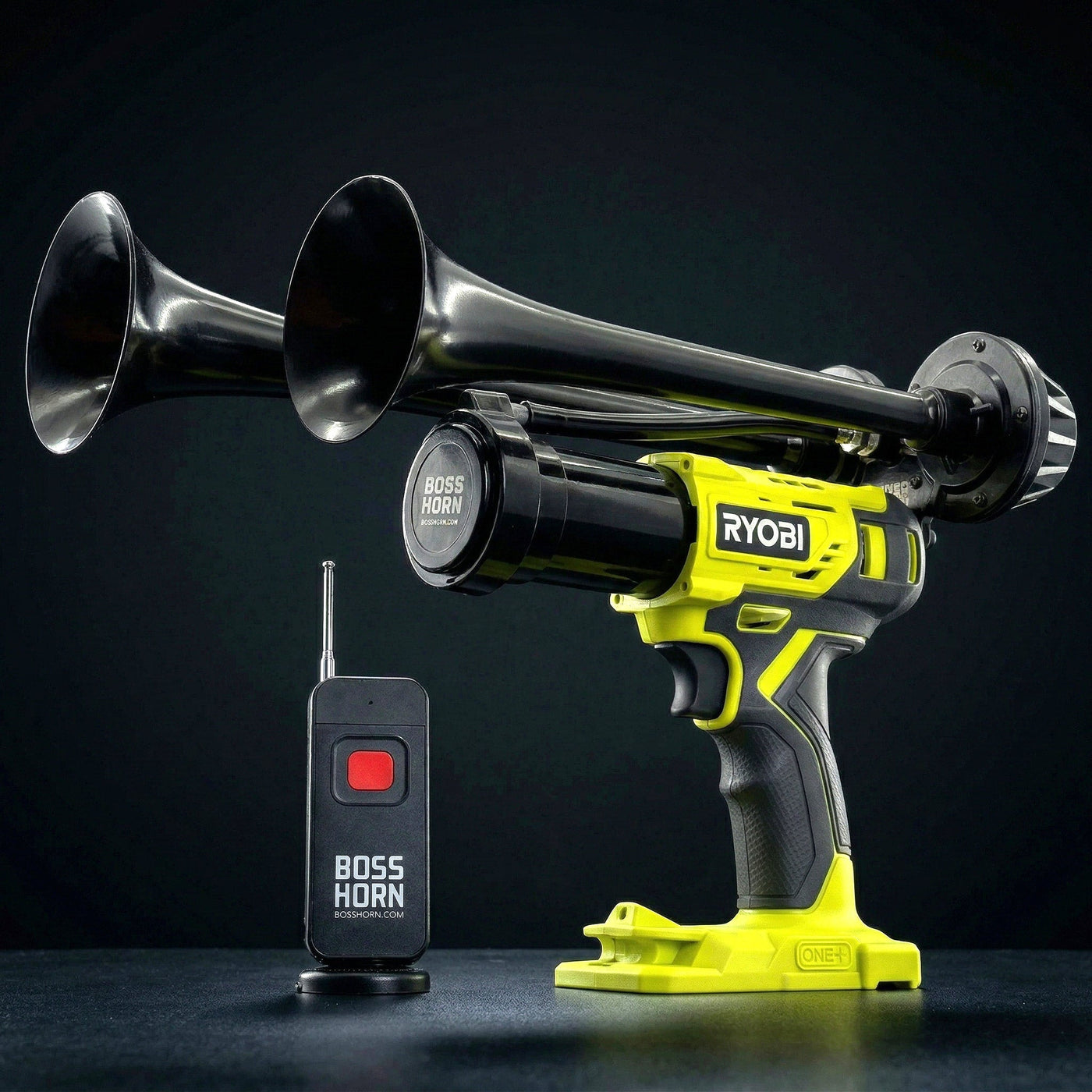 Black dual-trumpet wildlife deterrent camp horn with wireless remote on a dark background