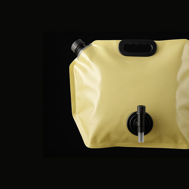 Yellow water storage bag with black valves on a black background